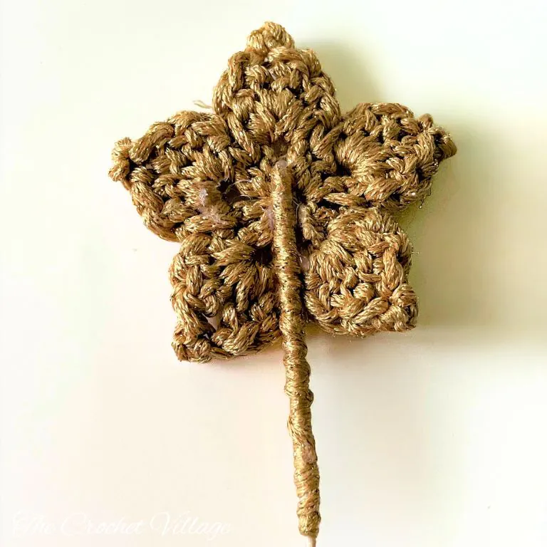A photo showing how to prepare the crochet star for attaching to the top of a 3D crochet Christmas tree.
