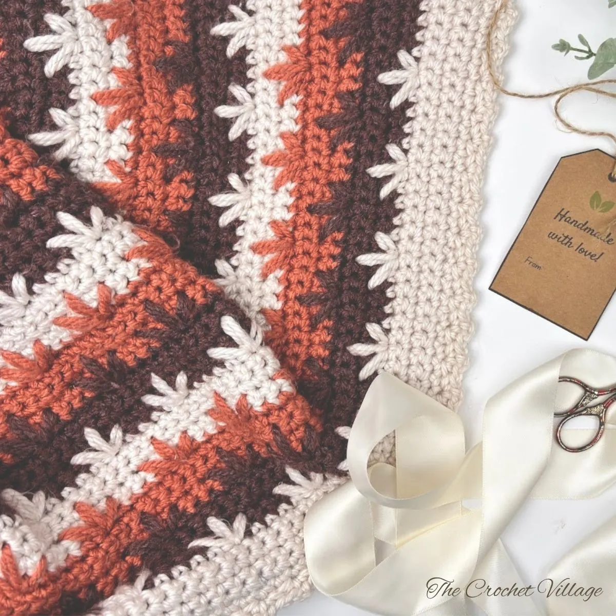 lose-up of a crochet fall leaves pattern, showing detailed stitches and warm autumn 