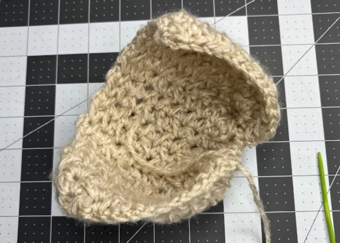 Crochet piece showing how to sew the rectangle to form a bauble ornament.