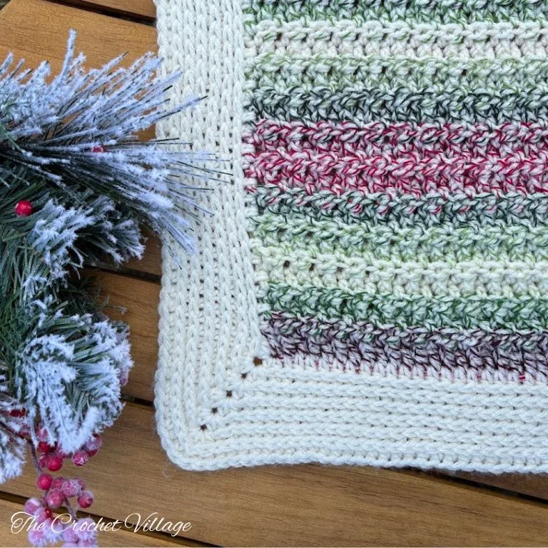 A close-up of a crochet Christmas piece showcasing a beautiful, simple border that complements the festive design.