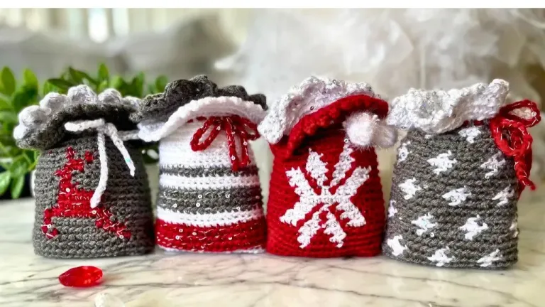 Four small, cute Christmas crochet gift bags featuring festive designs: a star, stripes, a snowflake, and a reindeer.