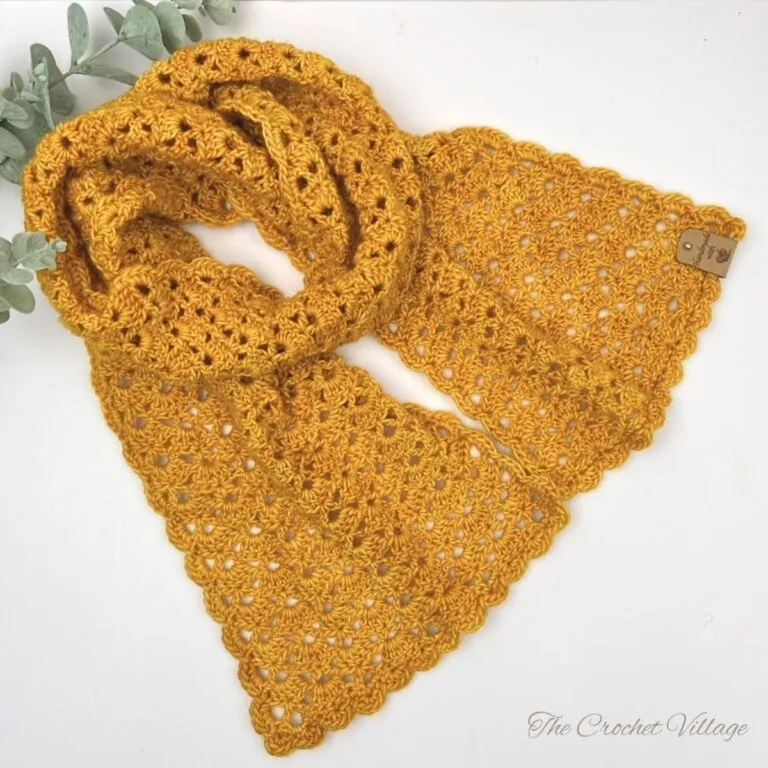 Lightweight crochet scarf made with DK weight yarn displayed on a white surface, showing texture and drape