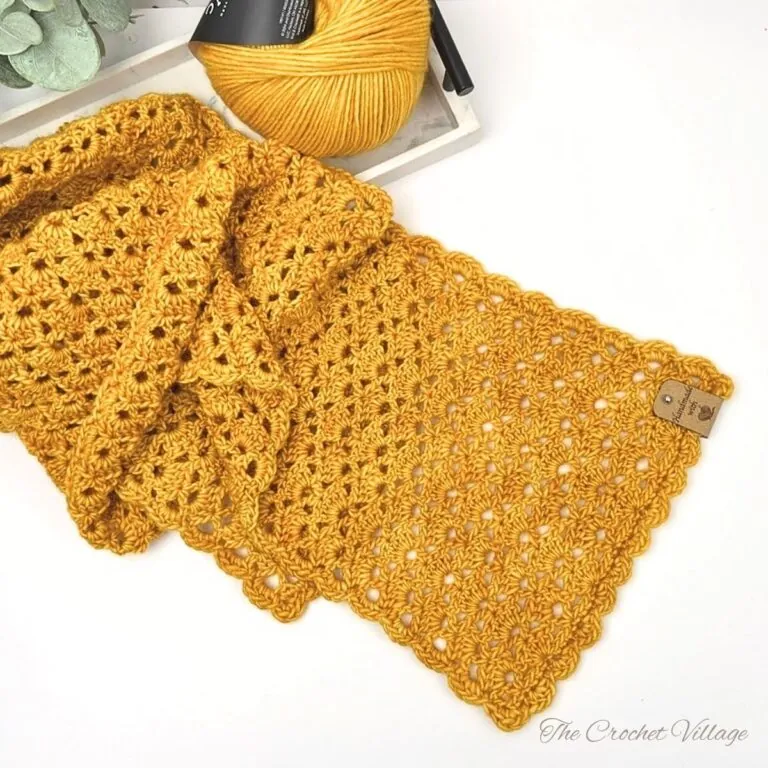 Handmade lightweight DK weight crochet scarf on a white background, highlighting the stitch texture and elegant drape.