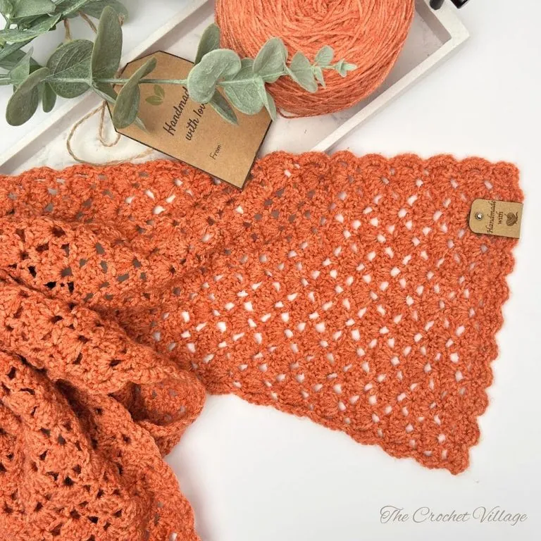 ightweight crochet scarf made with DK weight yarn displayed on a white surface, showing texture and drape