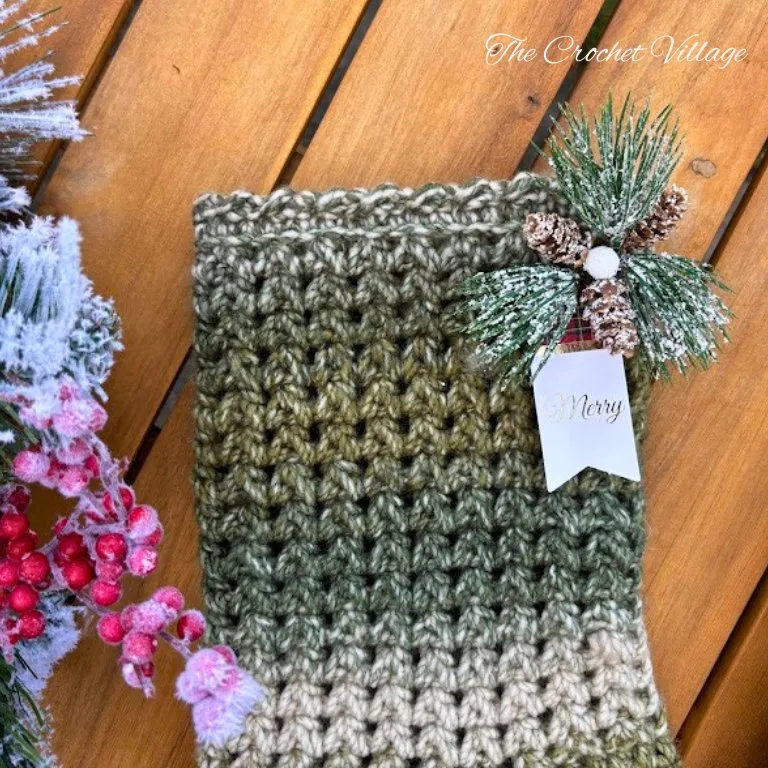 Close-up of a crochet Christmas stocking showing the textured stitch pattern and the beautifully finished decorative border.