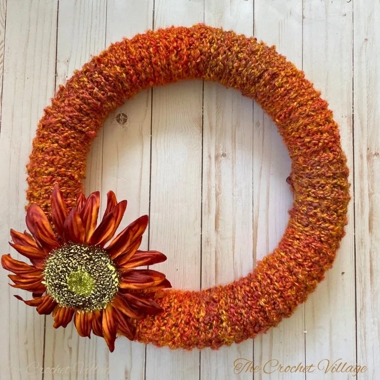Crochet wreath decorated with fall picks for autumn décor