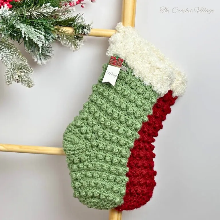 Large textured crochet Christmas stockings with faux fur trim displayed on decorated fireplace mantel