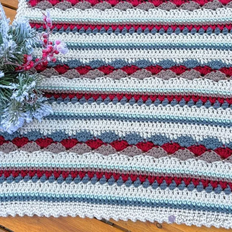 Close-up of reversible crochet scrap yarn blanket showing mixed stitches and multiple colors