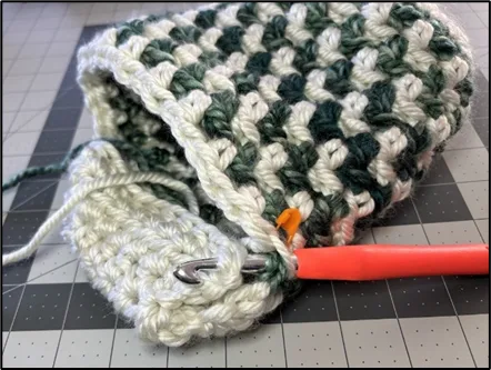 Progress photo showing the first step of crocheting the heel section of the Large Crochet Christmas Stocking.