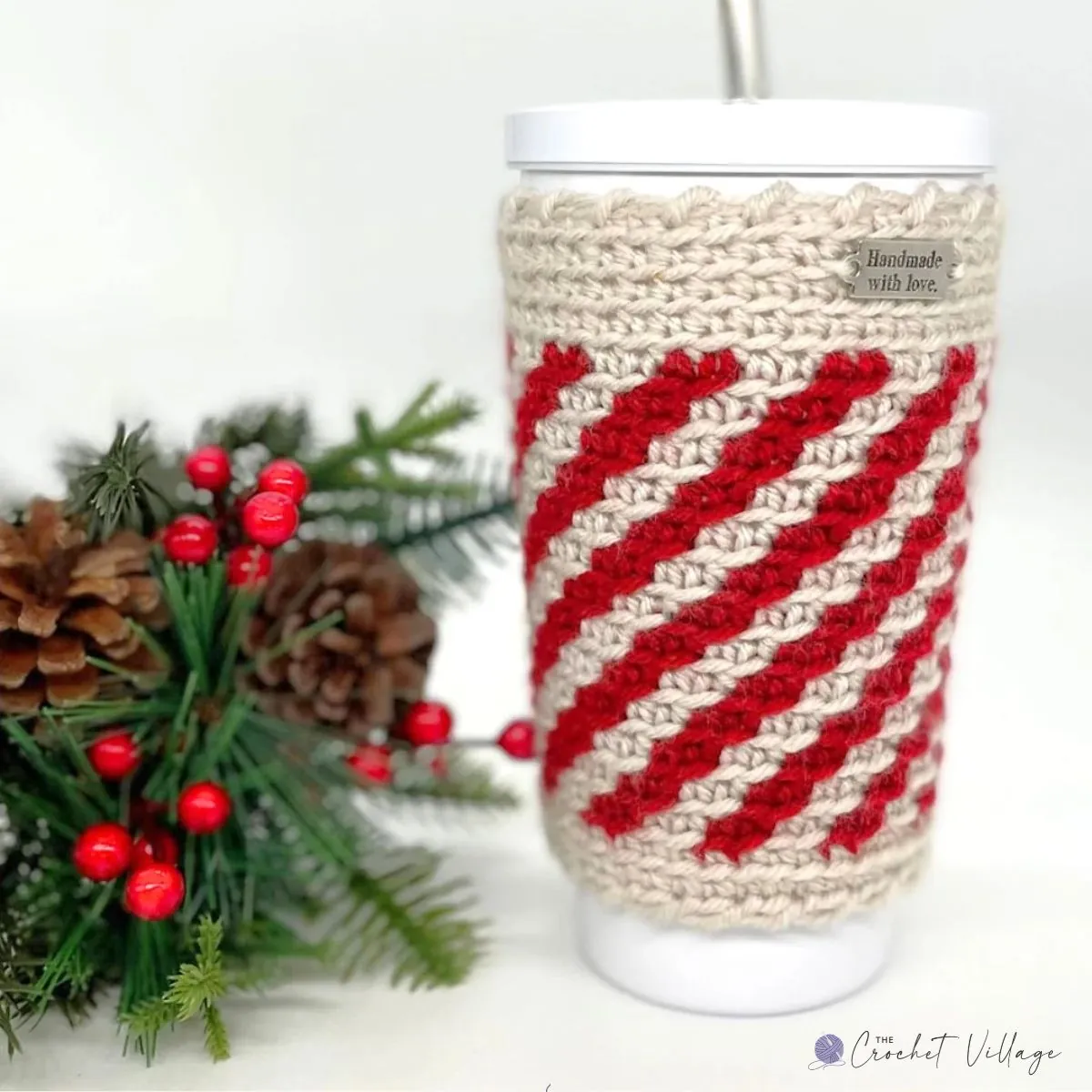 Crochet peppermint cup cozy in festive red and white stripes, designed to enhance grip on stainless steel travel mugs, perfect for Christmas gifting.