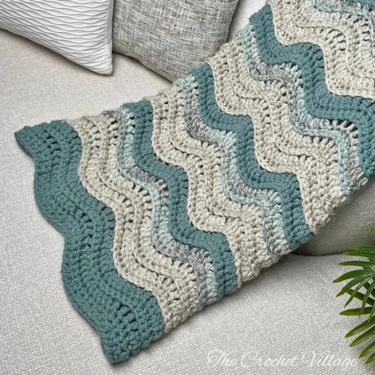 Chunky handmade crochet blanket on couch
