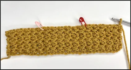 Close-up showing how to divide last row into 3 sections to make crochet tissue box holder top opening
