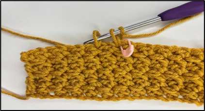 Progress image showing how to crochet the opening of tissue box cover
