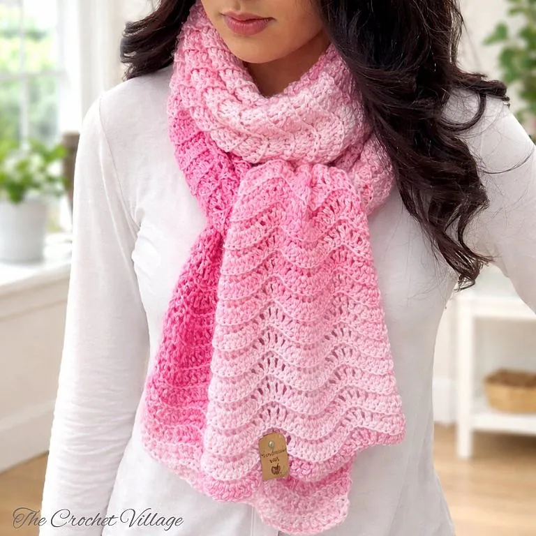 Woman modeling a soft, lightweight crocheted chevron ripple scarf in self-striping yarn