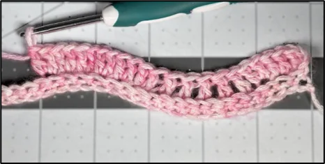 Close-up of chevron ripple stitch increases showing multiple stitches creating the peak waves