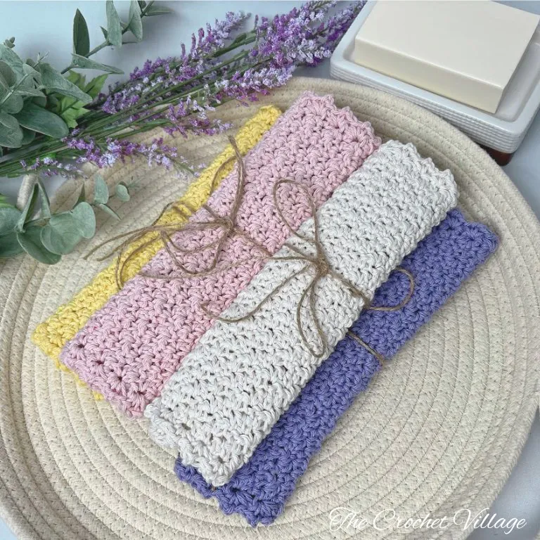 Four handmade crochet washcloths in different colors displaying the Melloy washcloth crochet pattern
