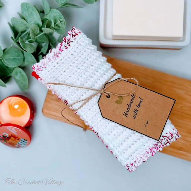 Crochet washcloth featuring white body with fun contrasting pink border in single crochet stitch pattern