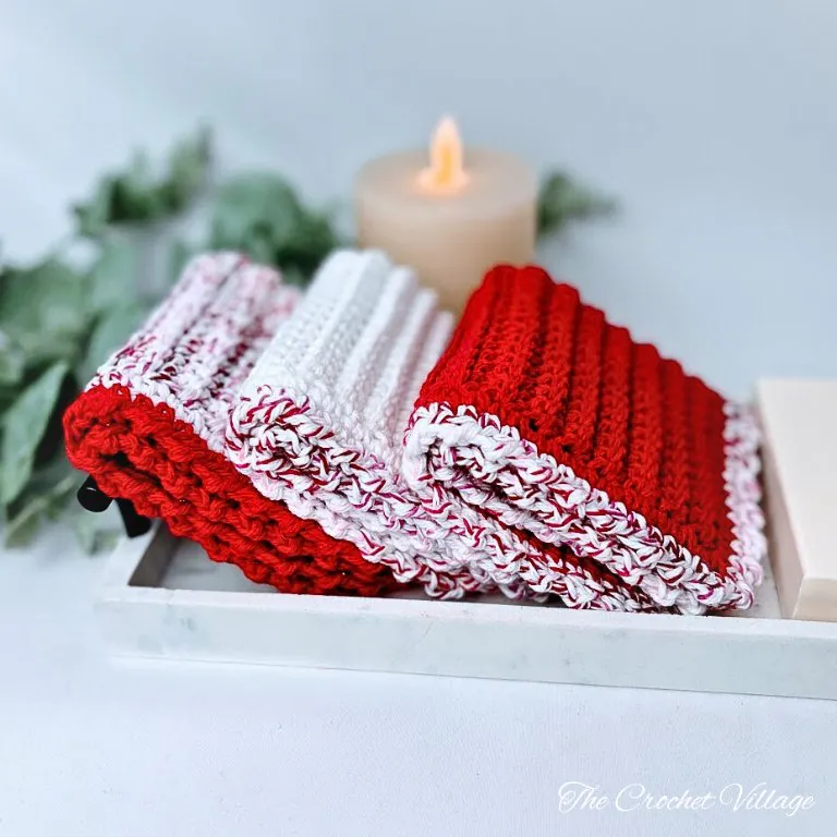 Three easy handmade crochet washcloths nicely folded in coordinating colors showing completed single crochet pattern set