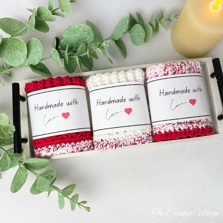 Crochet washcloth featuring red body with fun contrasting pink border in single crochet stitch pattern