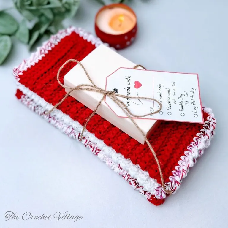 Completed crochet washcloths using basic single crochet stitches with a charming contrasting-color border. These beginner-friendly projects finish in about an hour