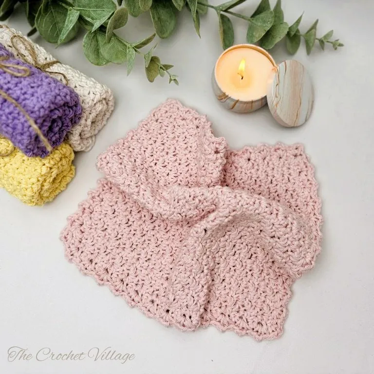 Close-up of a crochet washcloth displaying textured stitches and elegant edging detail.