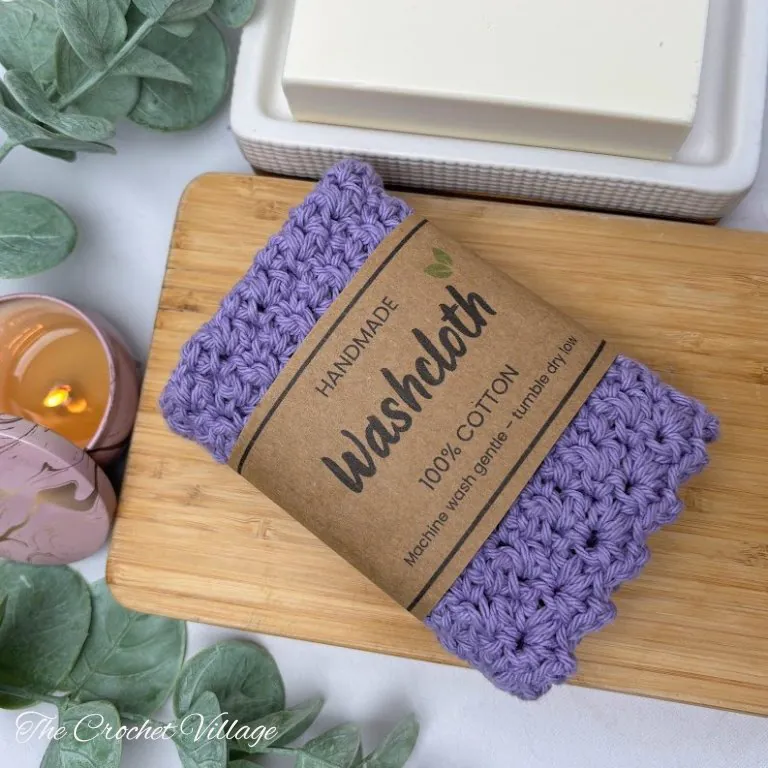 Handmade crochet washcloth gift wrapped with a printable gift wrap, ready to give as a present