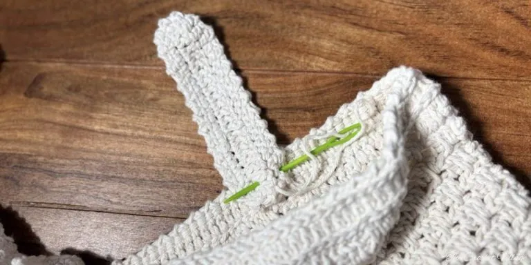 Tutorial showing how to attach closure strap to crochet crossbody bag flap