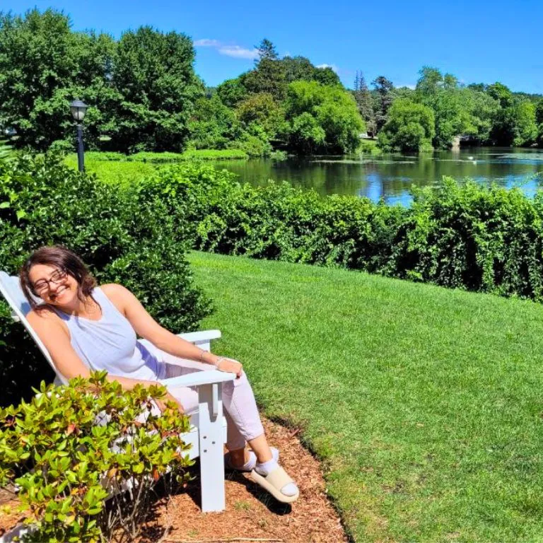 The Crochet Village designer by the pond, gathering inspiration from the peaceful scenery, colors, and textures of nature.