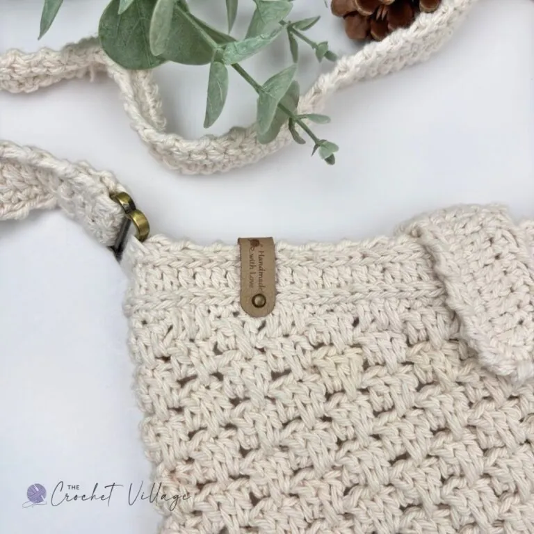 Close up of crochet closure flap detail on handmade Macchiato crossbody bag, cotton yarn texture