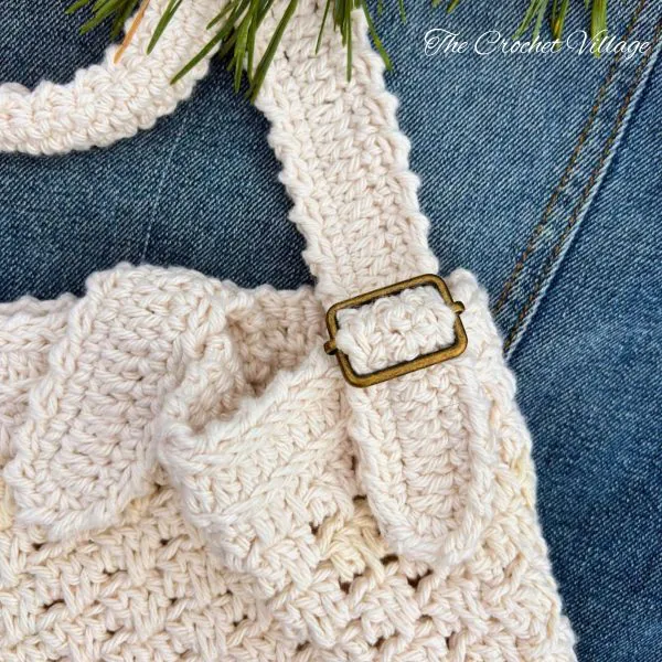 Close up of metal closure and crocheted strap handle on handmade Macchiato crossbody bag