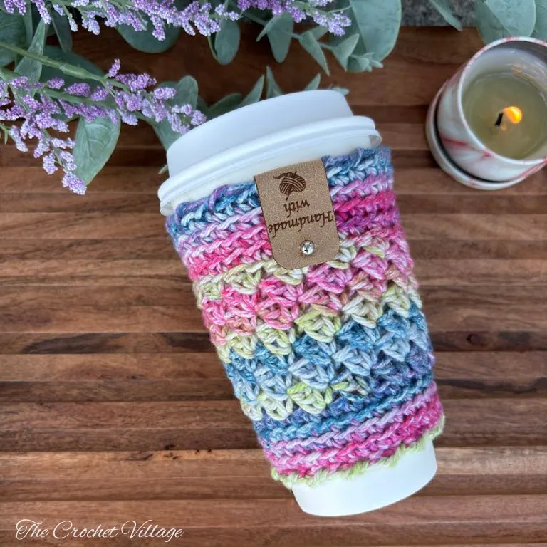 Handmade crochet cup cozy in Christmas colors - free crochet pattern perfect for teacher gifts and holiday gift baskets