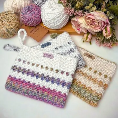 Three Milano free crochet clutch bags in different yarn colors — easy beginner small bag pattern using worsted weight cotton