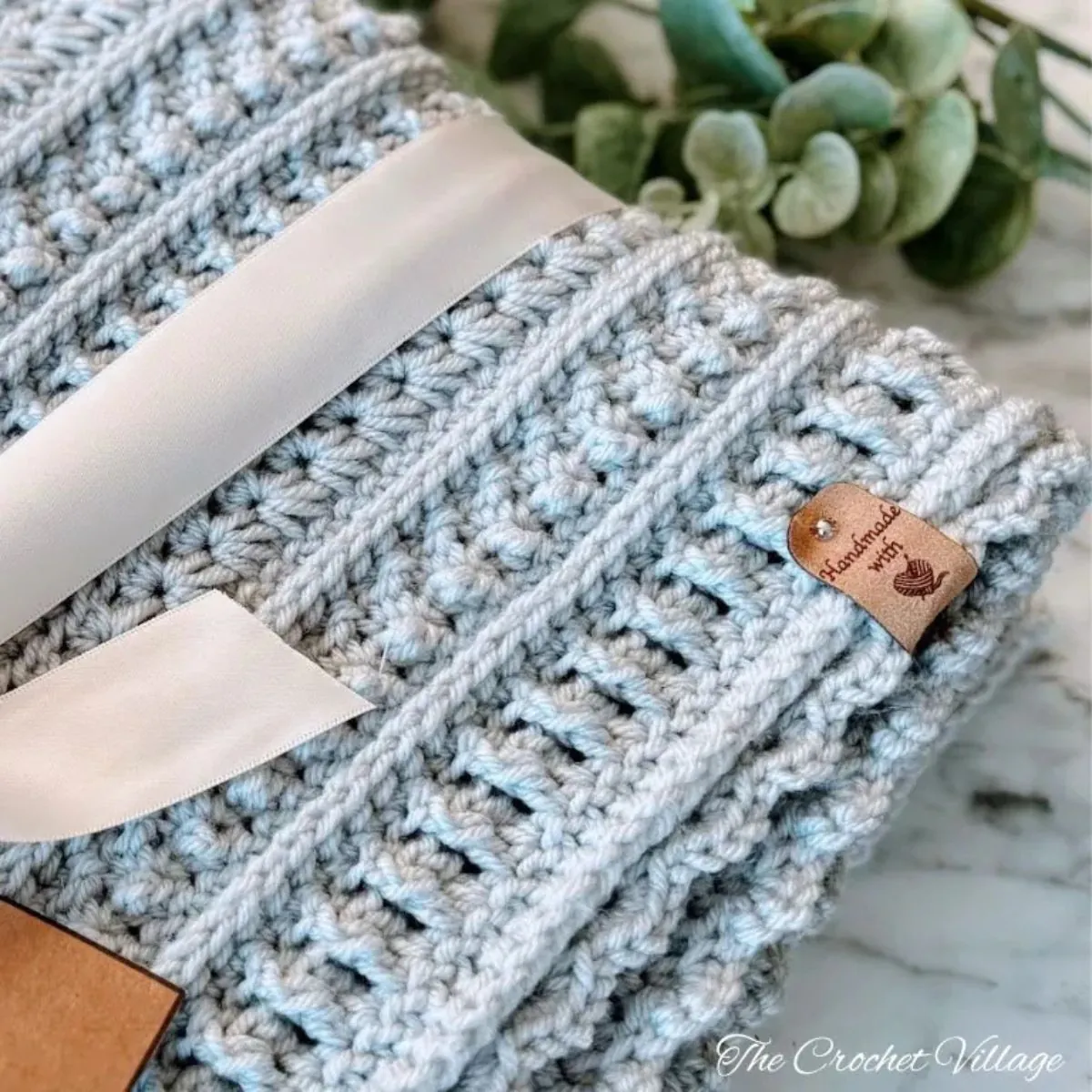 "Close-up of Sterling Blanket crochet sampler pattern showing textured stitch detail in light blue yarn