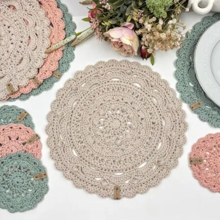 Round crochet placemat from the free Madison Table Set pattern in soft blush cotton yarn