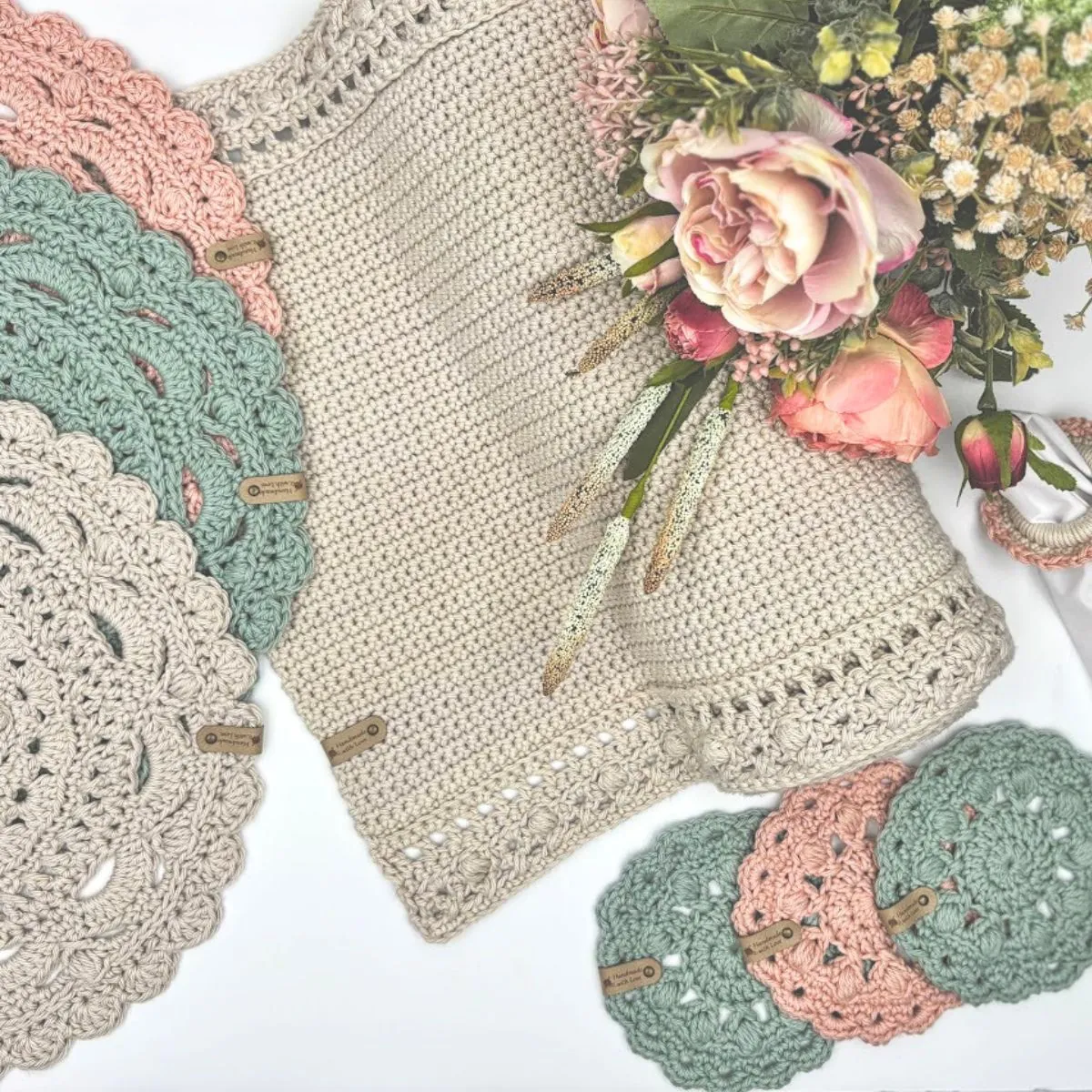 Madison Table Set flat lay — crochet table runner, round placemats, and coasters in cream, blush, and sage