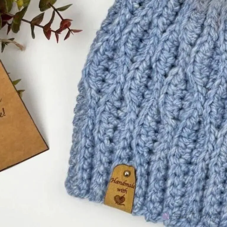 Close-up of light blue Geniva Hat showing stretchy wave-stitch texture - free chunky crochet hat