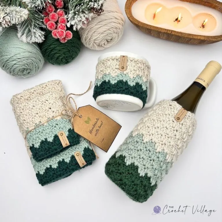 Crochet Christmas gift set — washcloth, towel, mug cozy, and wine bottle cozy in forest green, sage, and cream